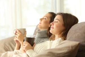 two-women-on-couch-looking-comfortable