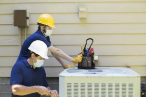 two-techs-working-on-outside-ac-unit