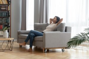 woman-looking-comfortable-in-home-leaning-back-on-couch