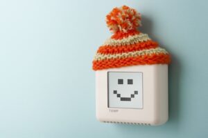 smart-thermostat-with-knit-wool-cap-and-smiley-face